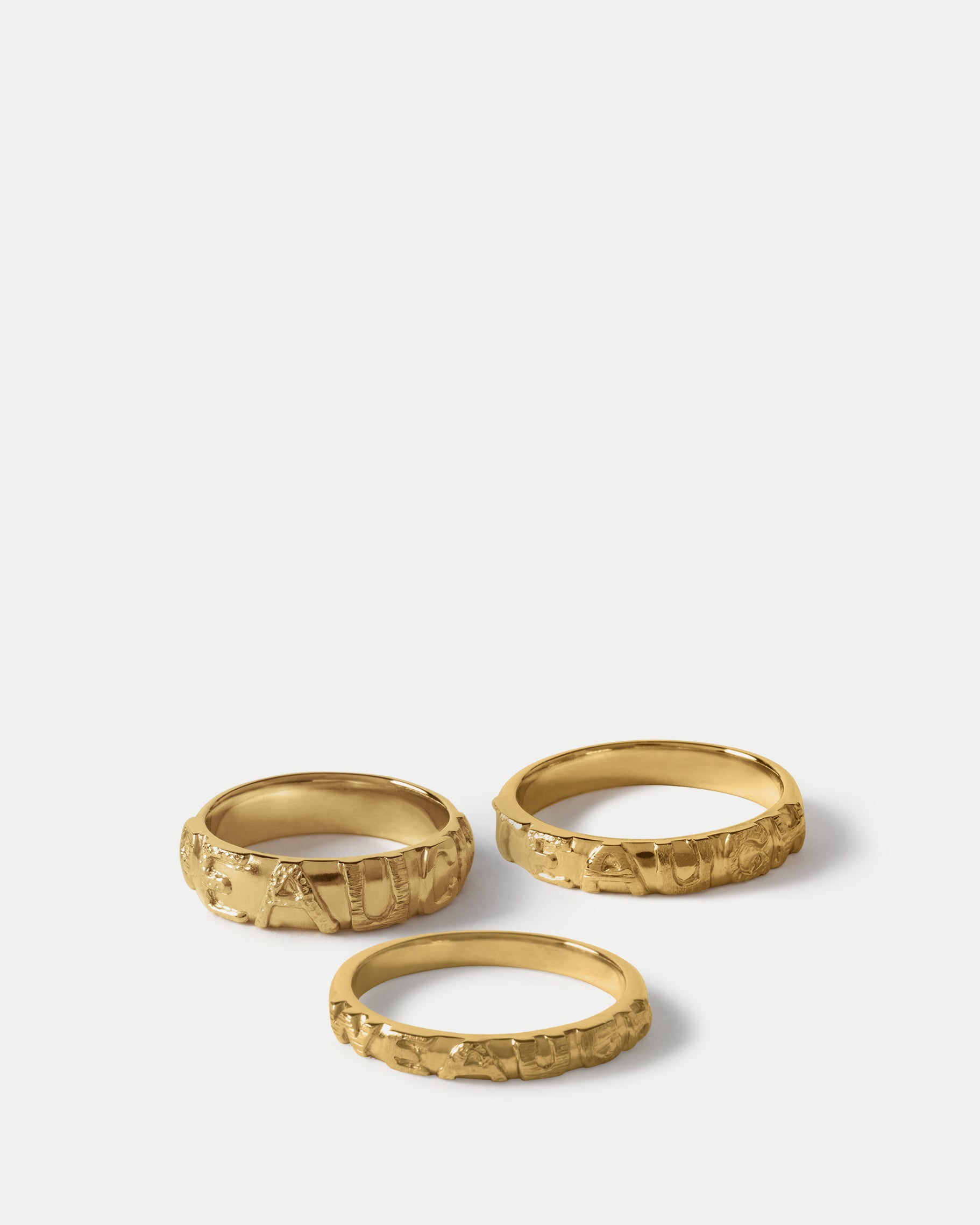 Angled view of Escrivá Narrow Band 2.5 in 14k yellow gold, Escrivá Classic Band 3.5 in 14k yellow gold, and Escrivá Wide Band 5 in 14k yellow gold