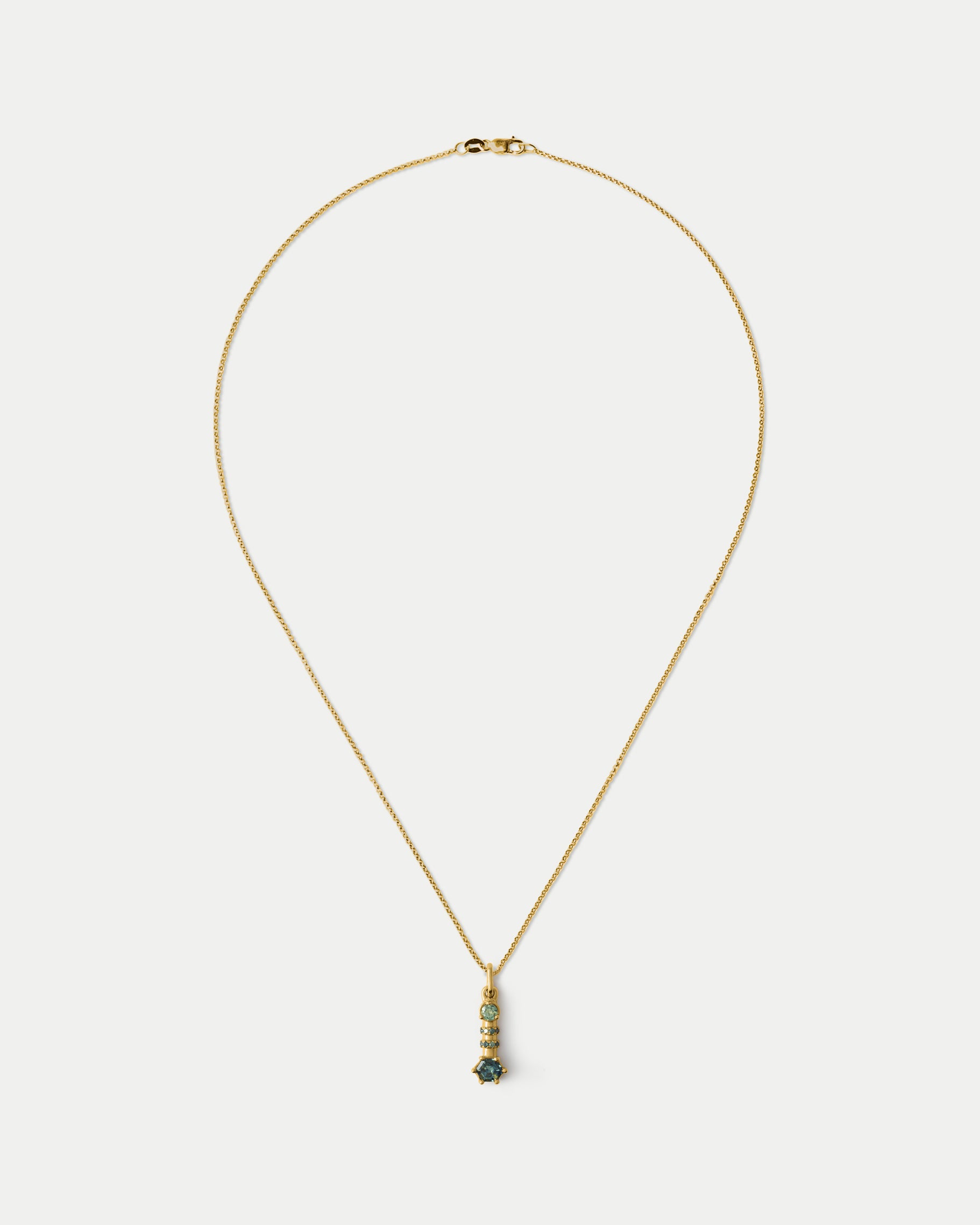 Front view of Monoceros Totem ft. Teal Sapphire in 14k yellow gold