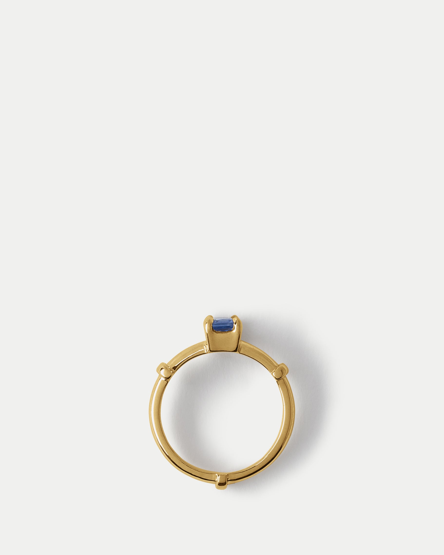 Flay lay view of Orion Solitaire Ring ft. Radiant Blue Sapphire in 14k yellow gold