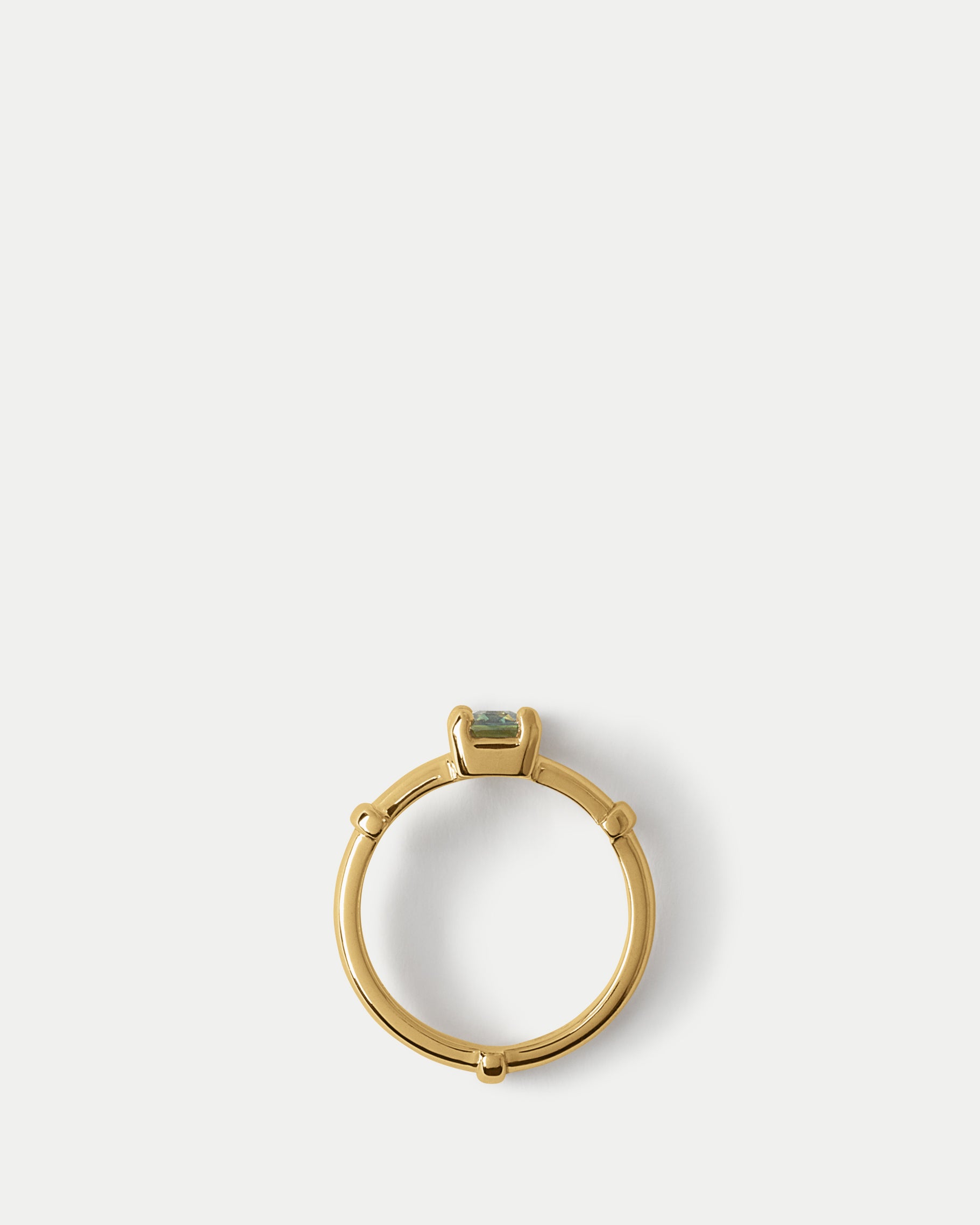 Flat lay view of Orion Solitaire Ring ft. Emerald Green Sapphire in 14k yellow gold