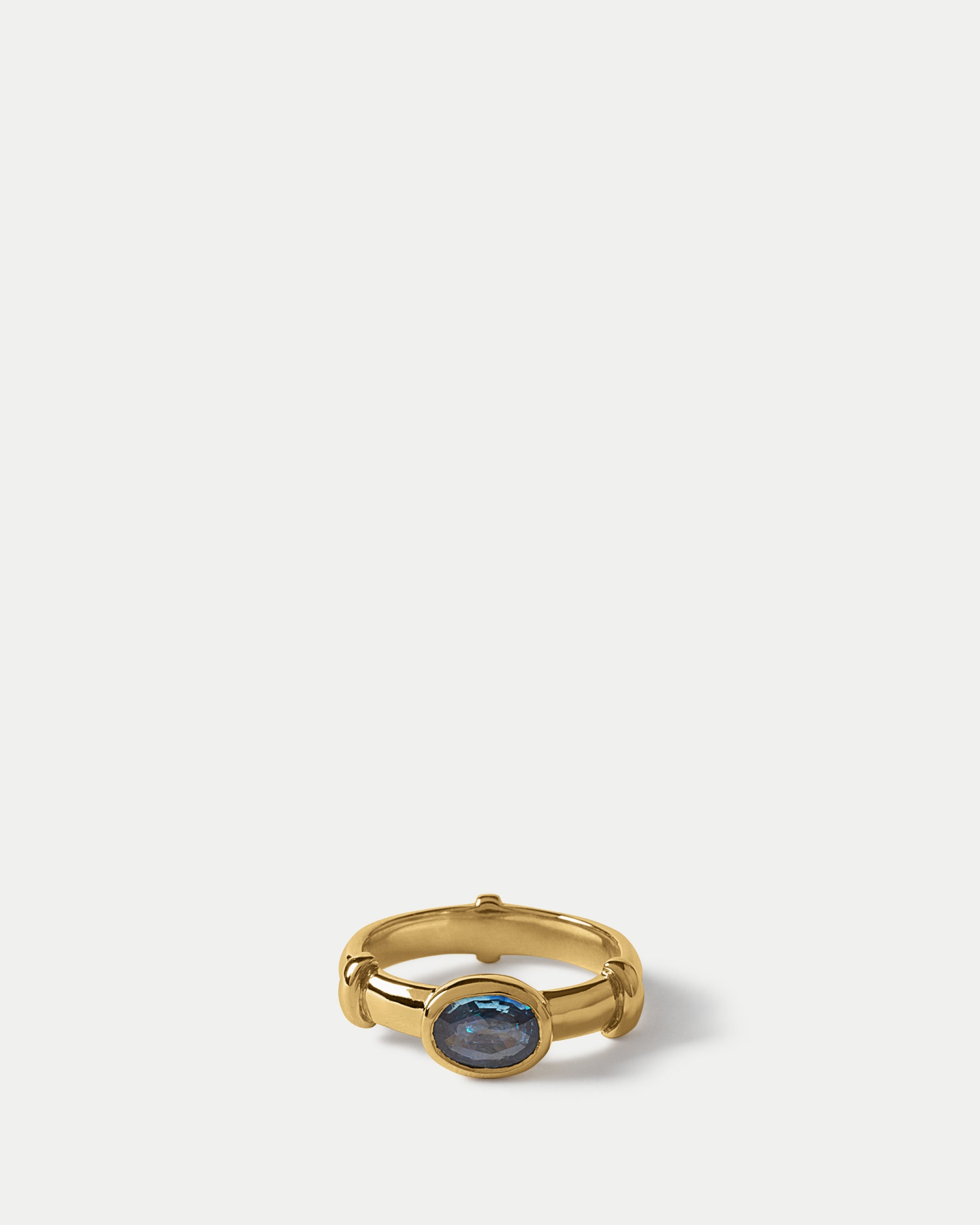 Angled view of Orion Solitaire Ring ft. Oval Blue Sapphire in 14k yellow gold