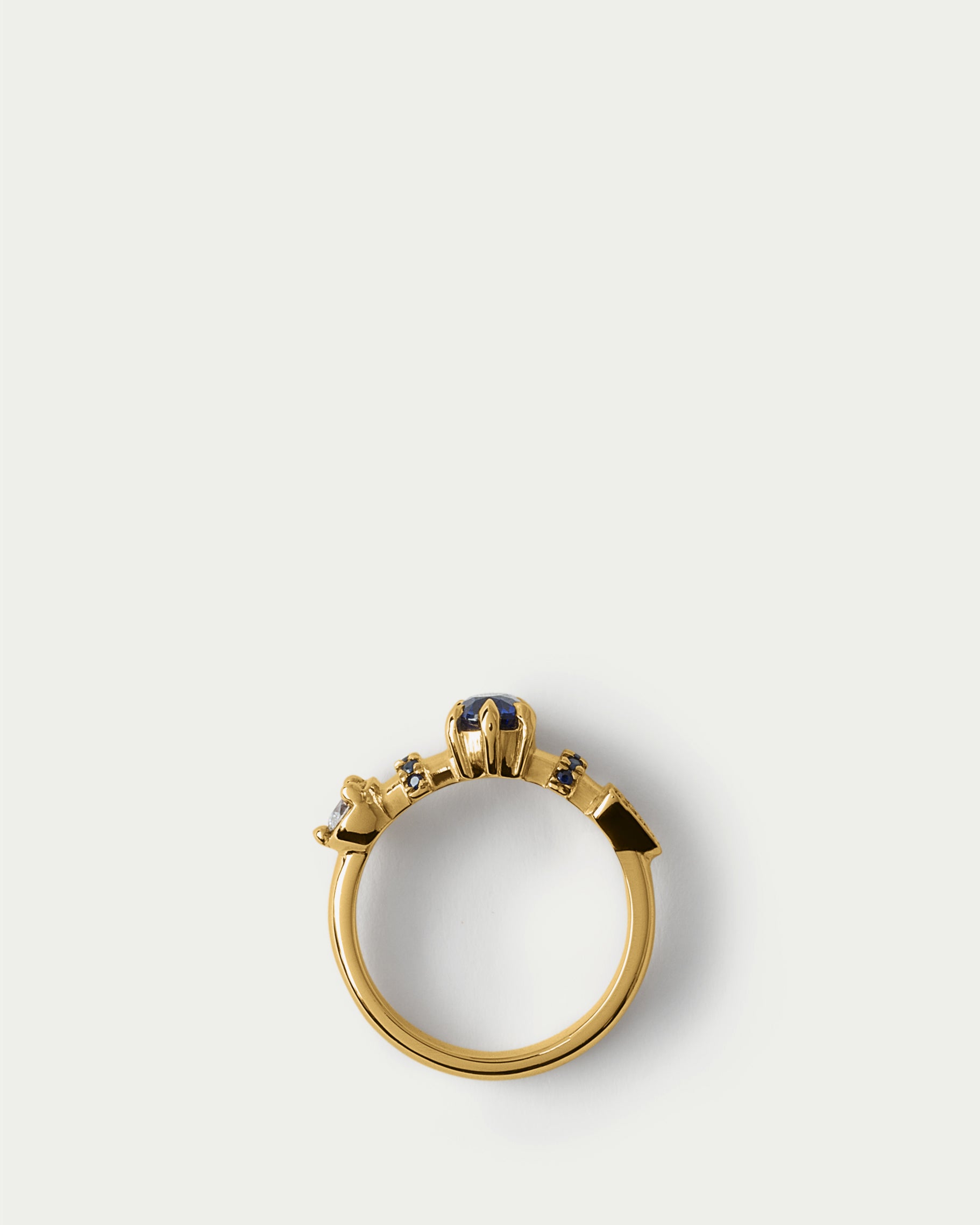 Flat lay view of Supernova Ring ft. Blue Sapphires & White Diamonds in 14k yellow gold